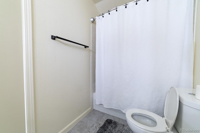 bathroom featuring toilet and shower / bathtub combination with curtain