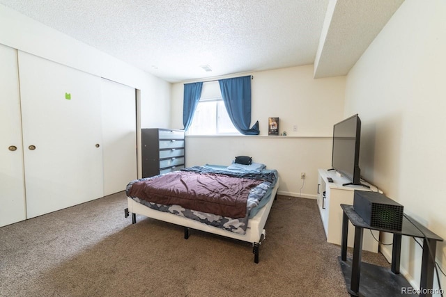 bedroom featuring a textured ceiling and carpet floors