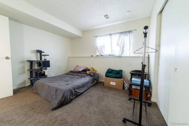 carpeted bedroom featuring a textured ceiling