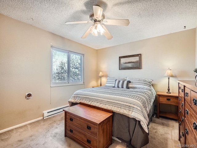 bedroom with ceiling fan, baseboard heating, light carpet, and a textured ceiling