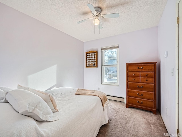 carpeted bedroom with a textured ceiling, ceiling fan, and a baseboard radiator