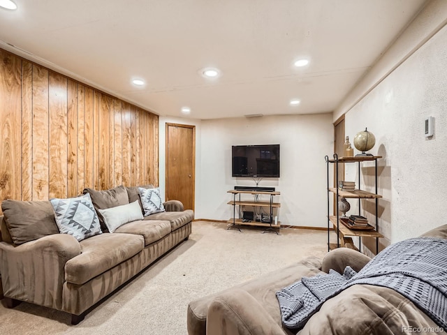 living room featuring light colored carpet and wood walls