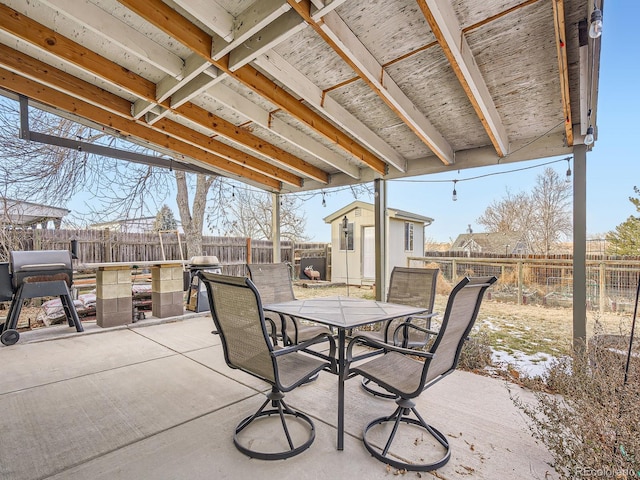 view of patio with area for grilling and an outbuilding