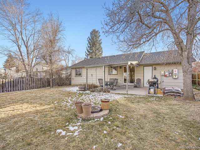 back of house featuring a yard and a patio area