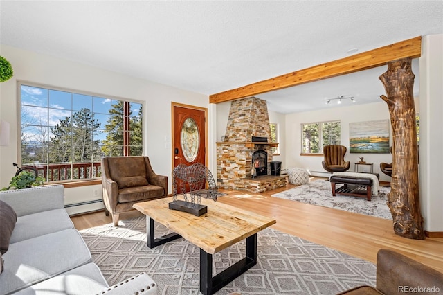 living room featuring beamed ceiling, wood finished floors, and a baseboard radiator