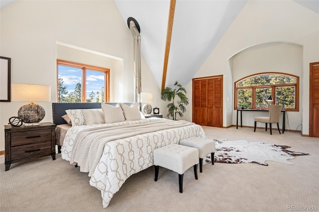 bedroom featuring light colored carpet, high vaulted ceiling, and baseboards