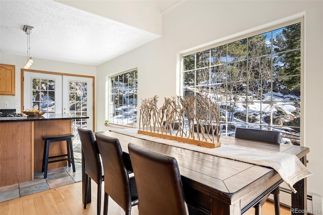 439 Ronnie Rd, Golden, CO 80403 - dining area featuring light wood-style flooring, a textured ceiling, and french doors