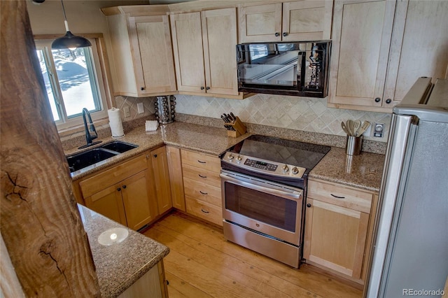68 Starlit Ln, Blue River, CO 80424 - kitchen with light wood-style floors, tasteful backsplash, a sink, stainless steel appliances, and light brown cabinets