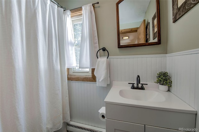 68 Starlit Ln, Blue River, CO 80424 - bathroom with a shower with curtain, a baseboard heating unit, wainscoting, and vanity