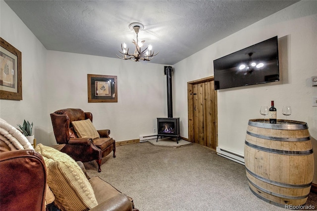68 Starlit Ln, Blue River, CO 80424 - living room featuring a chandelier, a wood stove, carpet, and a baseboard radiator