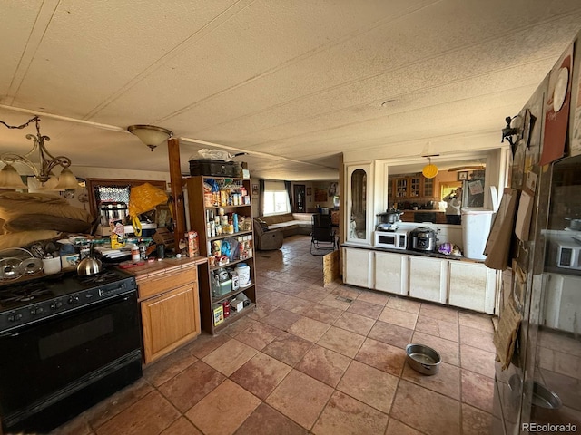 kitchen featuring pendant lighting and black range with gas cooktop