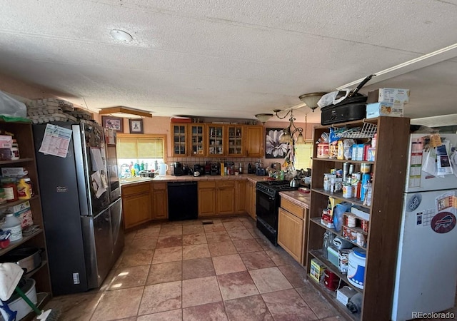 kitchen featuring tasteful backsplash, a textured ceiling, and black appliances