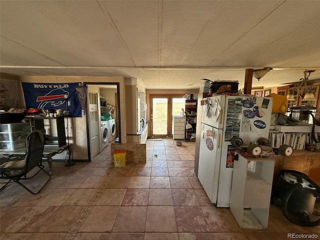 kitchen with washing machine and clothes dryer and white fridge