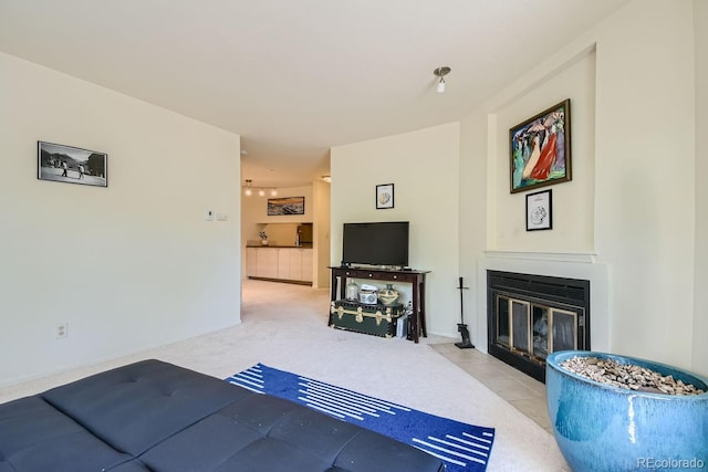 living room featuring light carpet and a fireplace