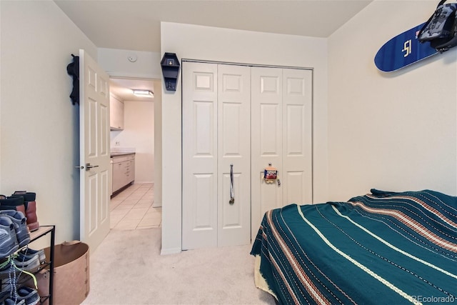 bedroom featuring light carpet and a closet