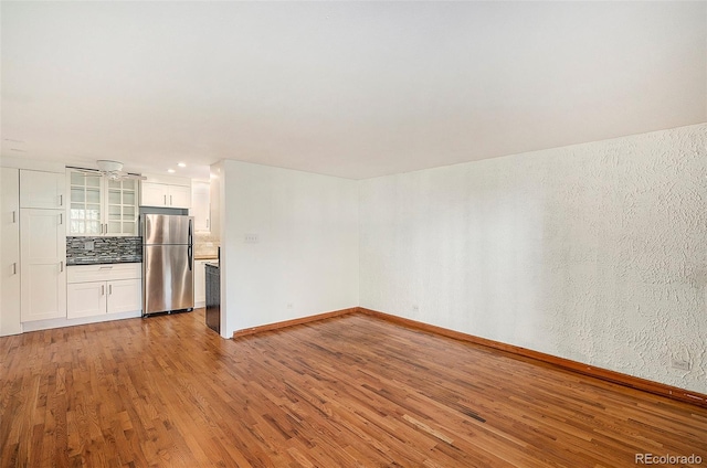 unfurnished living room with hardwood / wood-style floors