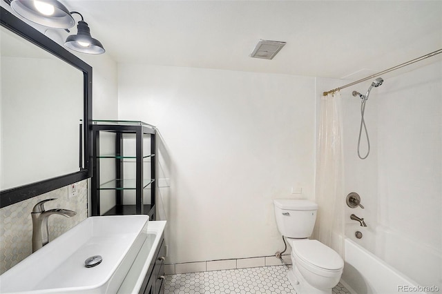 full bathroom featuring vanity, shower / bathtub combination with curtain, tile patterned floors, and toilet