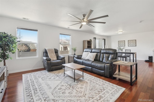 living room with ceiling fan and dark hardwood / wood-style flooring