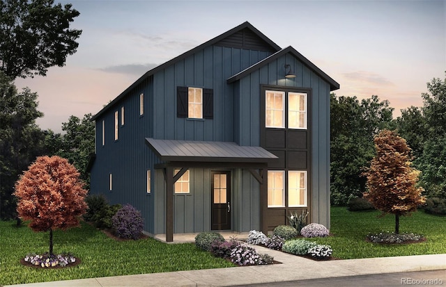 modern farmhouse featuring a standing seam roof, metal roof, board and batten siding, and a yard