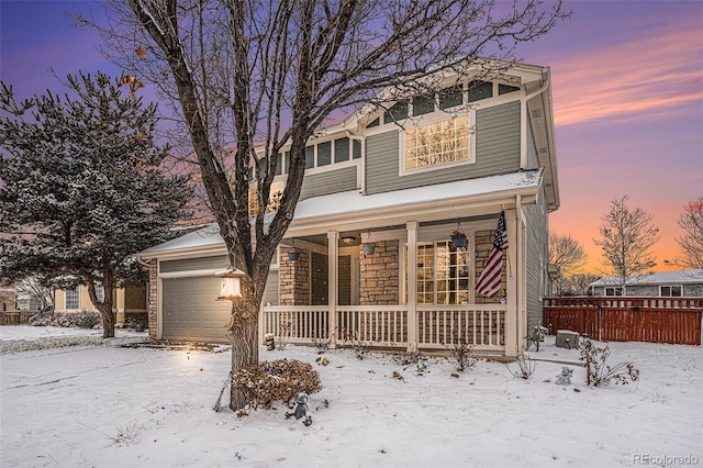 view of front of property featuring a garage and covered porch