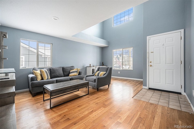 living room featuring baseboards and light wood finished floors