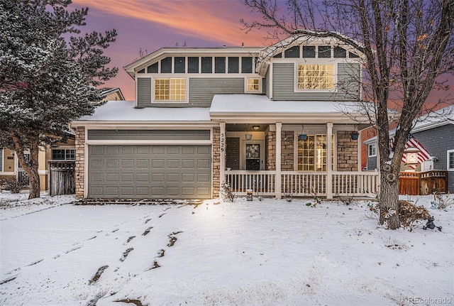 view of front of home featuring a garage, covered porch, and stone siding