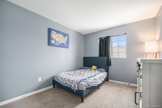 bedroom featuring carpet flooring and baseboards