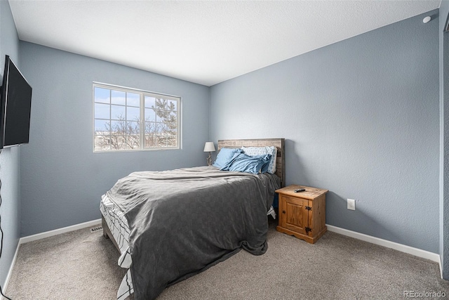 carpeted bedroom featuring baseboards