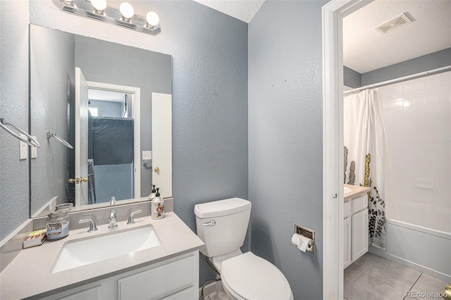 full bathroom with visible vents, a textured wall, and toilet