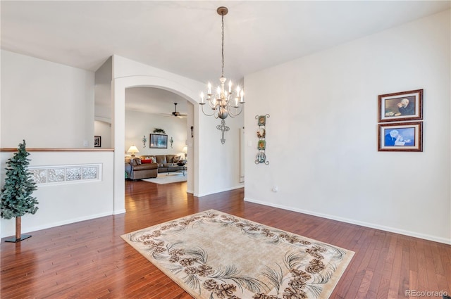 dining room featuring ceiling fan with notable chandelier and wood-type flooring