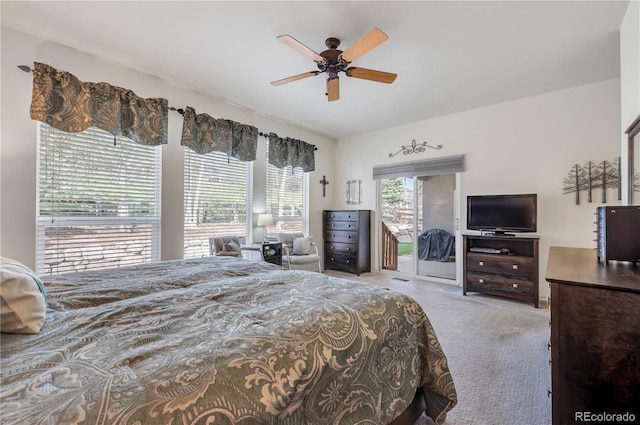 bedroom with ceiling fan, multiple windows, access to exterior, and light carpet