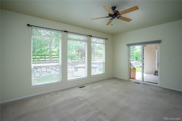 spare room featuring ceiling fan and light carpet