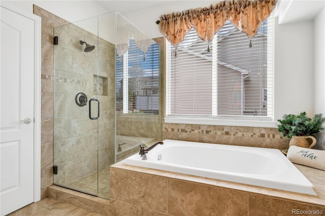 bathroom with tile patterned flooring, plenty of natural light, and plus walk in shower