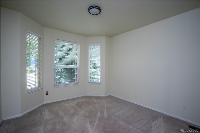 unfurnished room featuring carpet