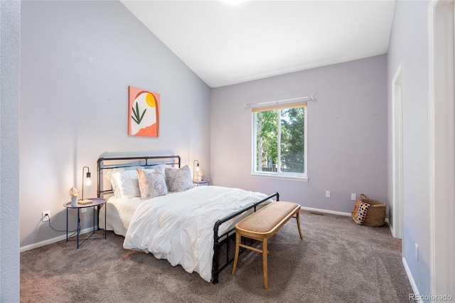 carpeted bedroom featuring lofted ceiling and baseboards
