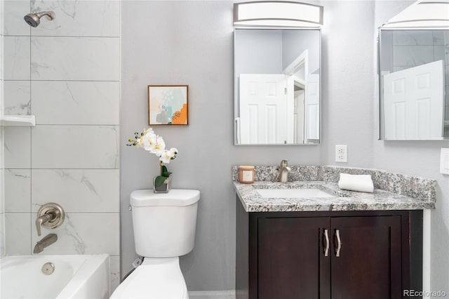 bathroom featuring toilet, vanity, and shower / washtub combination