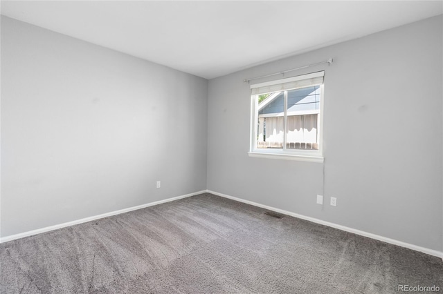 carpeted spare room with baseboards