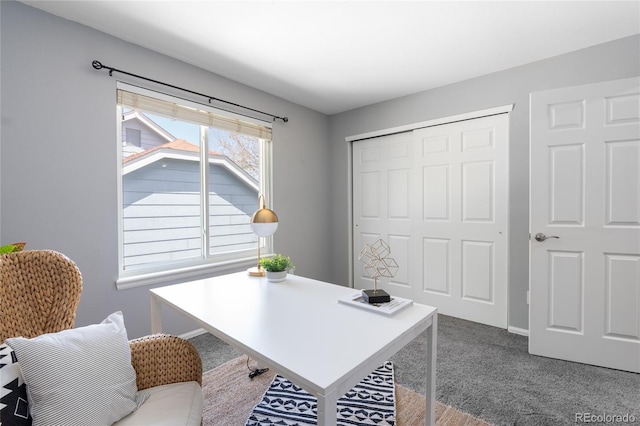 office featuring dark carpet and baseboards