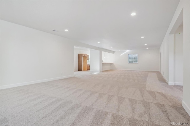 unfurnished living room with light colored carpet