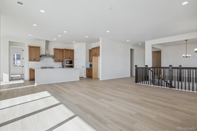 living room featuring a chandelier and light hardwood / wood-style flooring