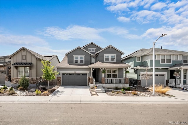 craftsman-style home featuring a garage, covered porch, board and batten siding, and concrete driveway