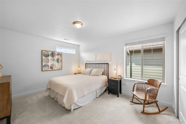 bedroom featuring light colored carpet, visible vents, and baseboards