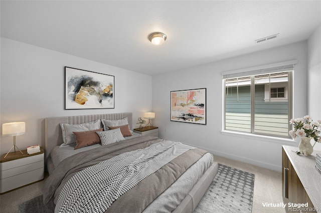 bedroom featuring baseboards, light carpet, and visible vents