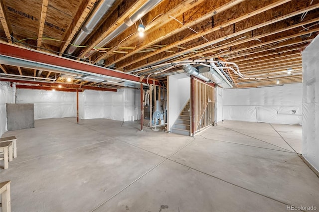 unfinished basement featuring stairs