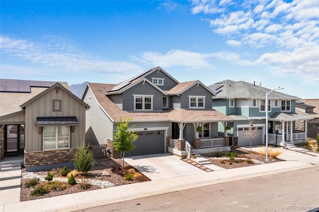 craftsman inspired home with concrete driveway, covered porch, and an attached garage