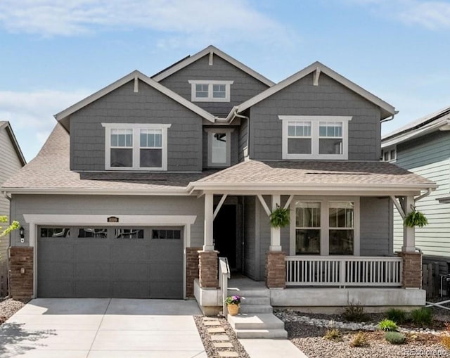 craftsman-style home featuring a porch, an attached garage, a shingled roof, and driveway