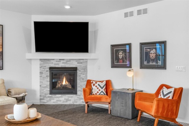 8109 Mount Ouray Rd, Littleton, CO 80125 - living area with baseboards, visible vents, and a fireplace