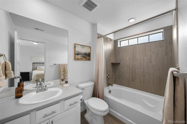 8109 Mount Ouray Rd, Littleton, CO 80125 - full bathroom featuring visible vents, vanity, shower / bath combination with curtain, toilet, and ensuite bath