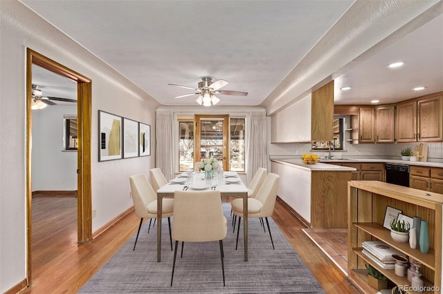 dining room with a ceiling fan, baseboards, wood finished floors, and recessed lighting