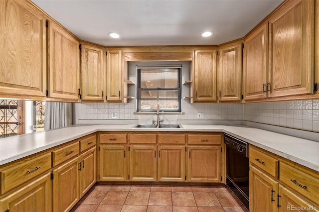 kitchen featuring dishwasher, a sink, light countertops, backsplash, and light tile patterned flooring